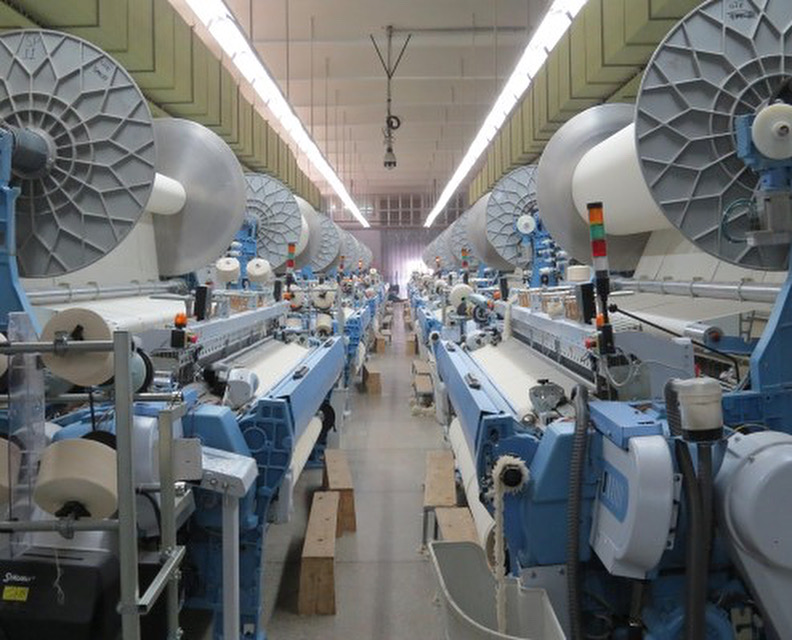 Modern textile weaving machinery used in Zena Tex production